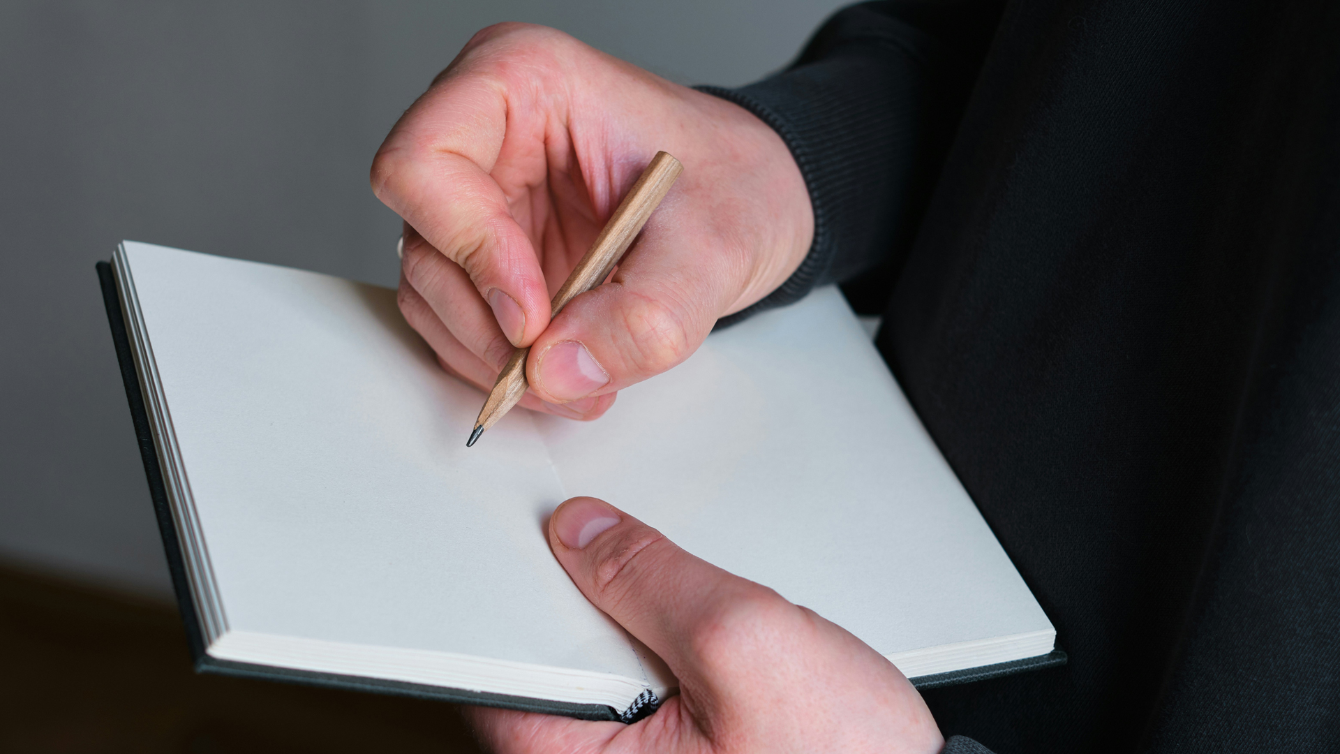 Photograph of someone writing on paper.
