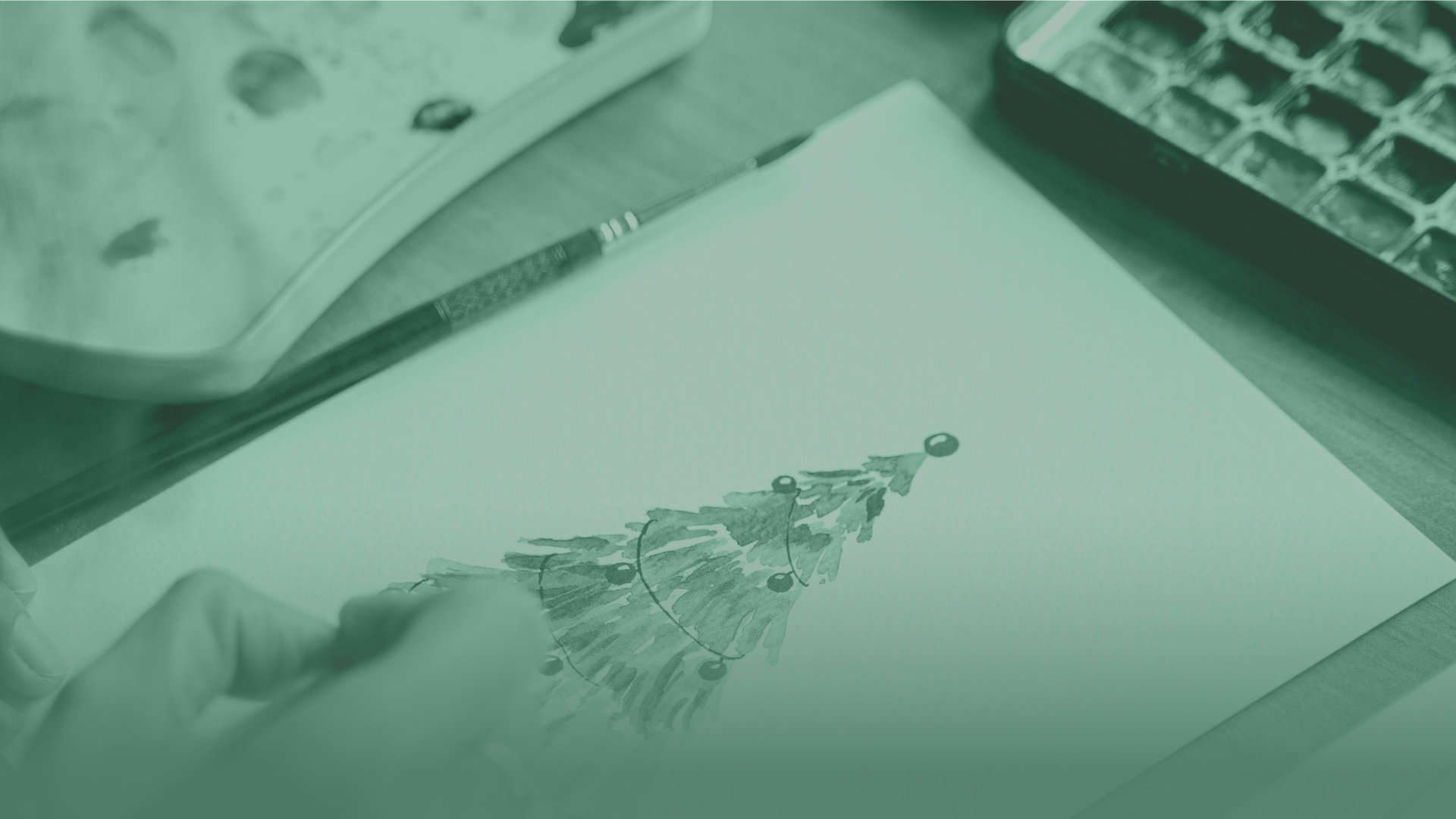 An image of someone drawing a Christmas tree.