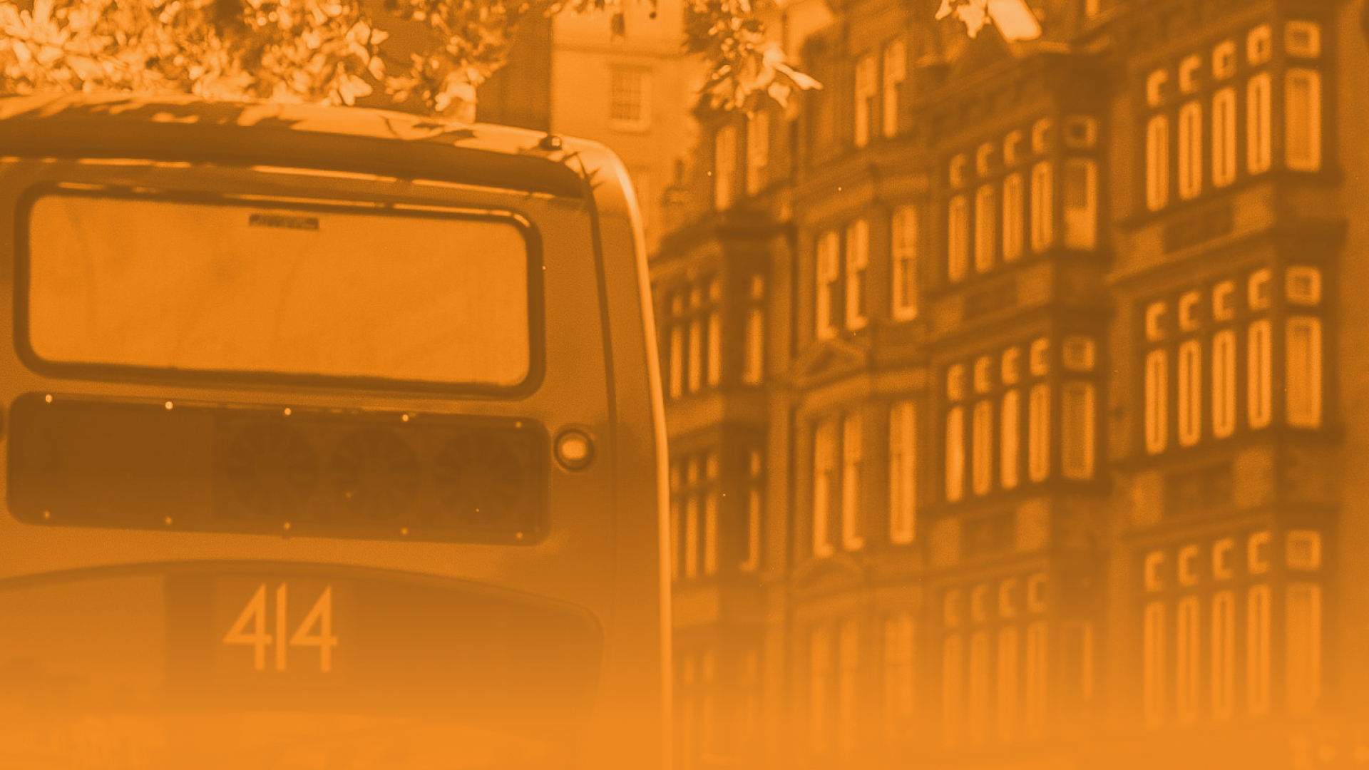 Image of the top of a bus with houses in the background