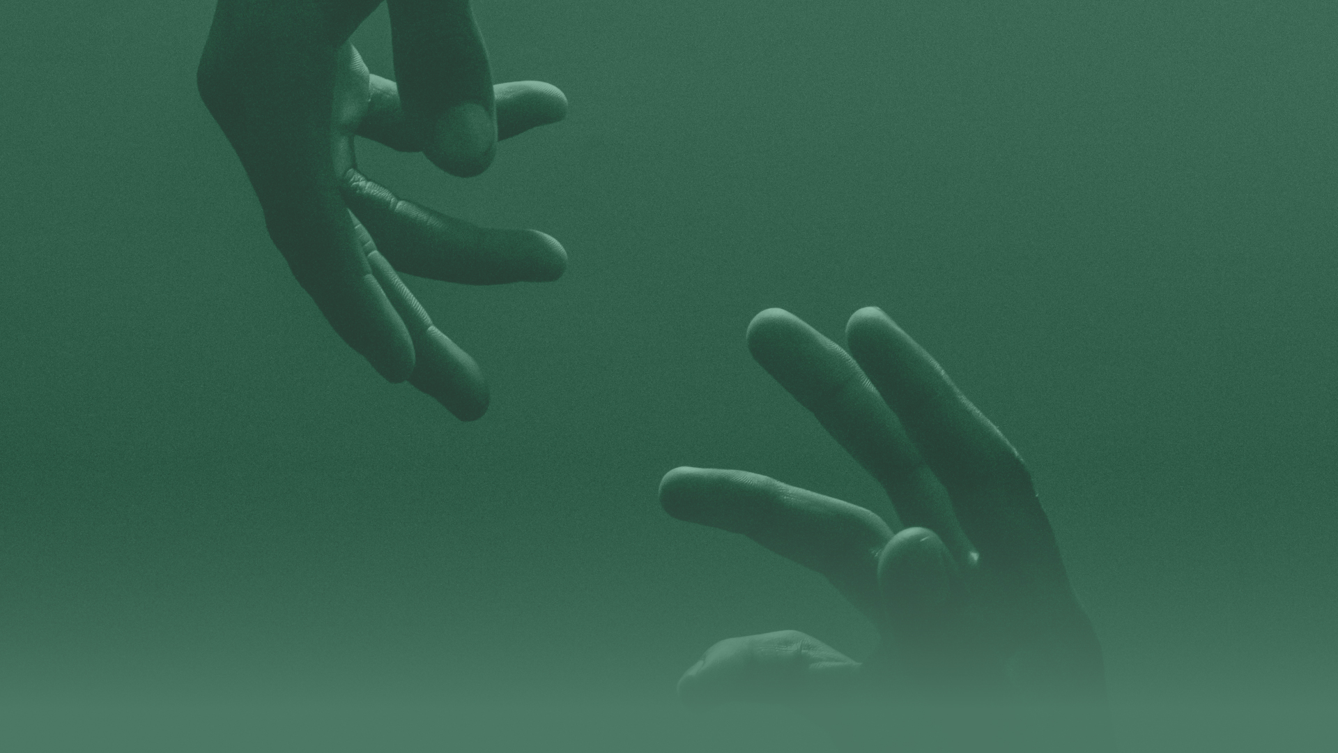 An close-up image of two hands reaching out towards each other.