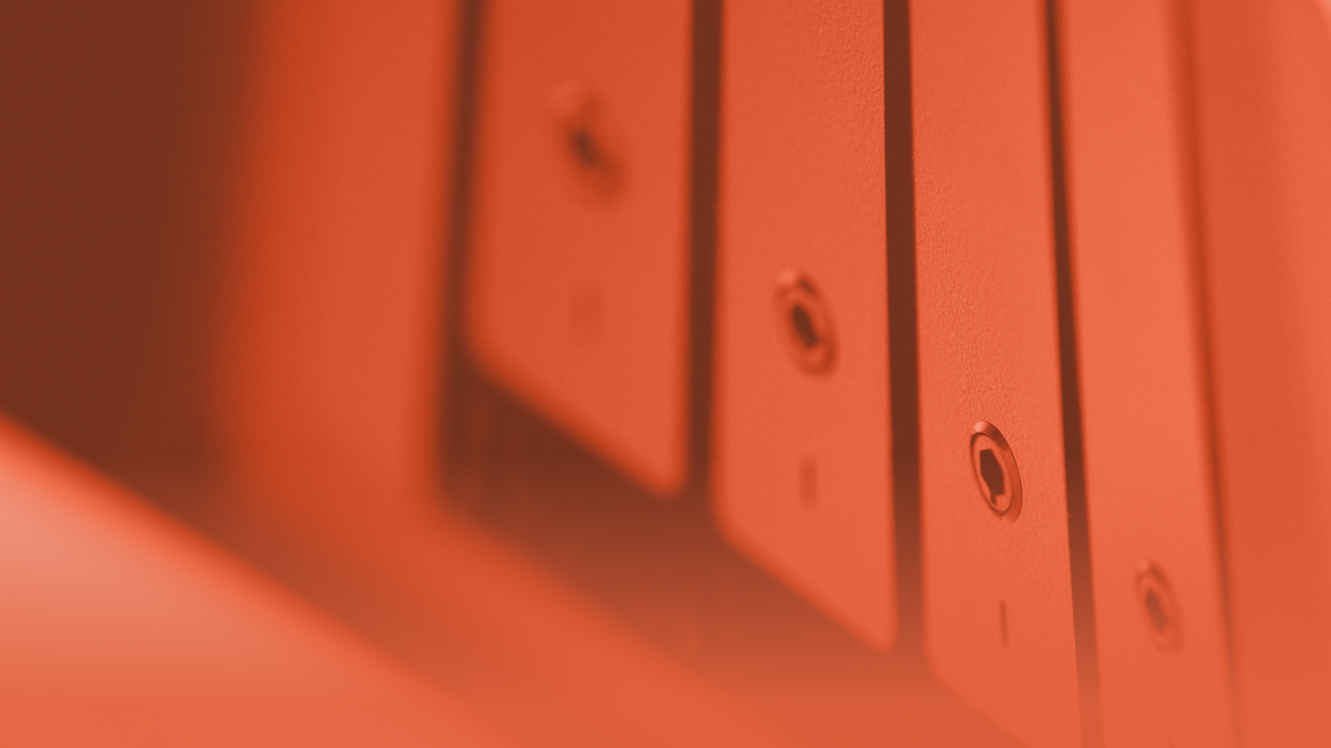 Close-up of switches on a wall, in orange tones.