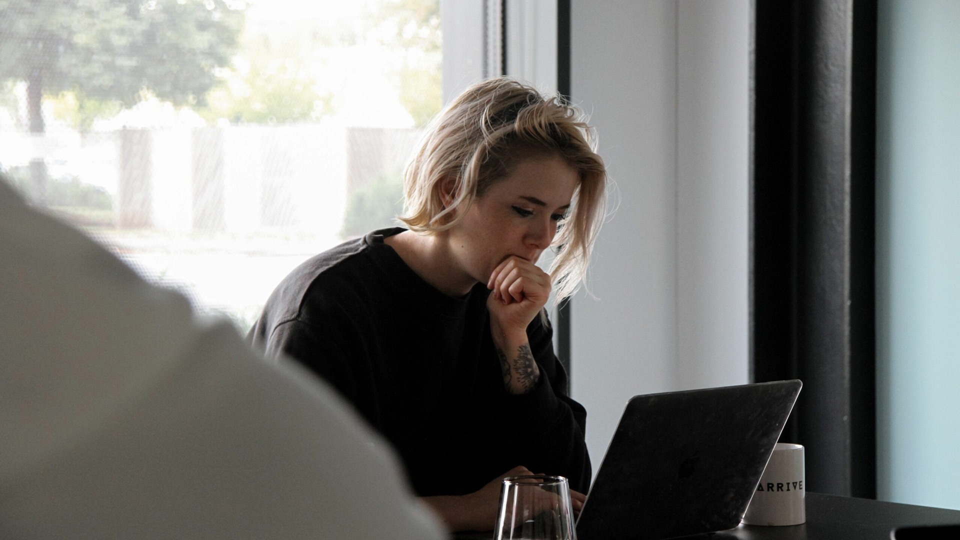 Image of person looking at laptop.