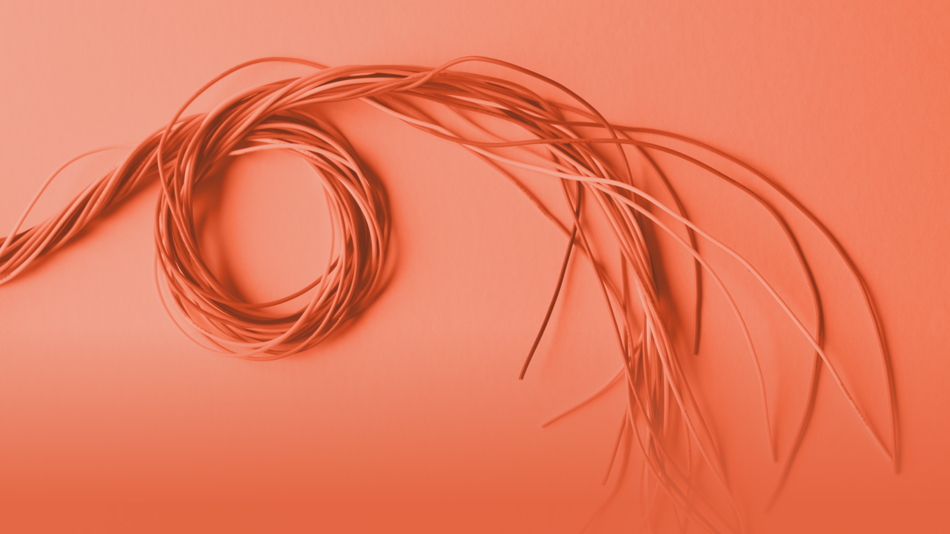 Abstract image of threads on orange background.