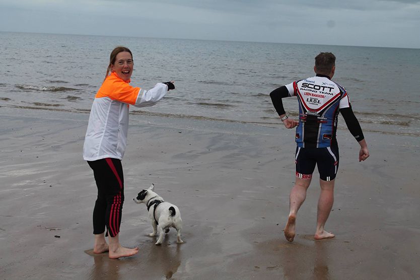 Photograph of people at the beach entering the sea