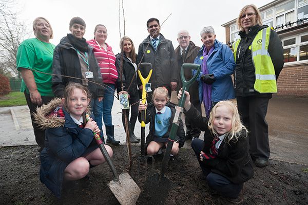 Photograph of Schoolchildren and Adults Planting Trees