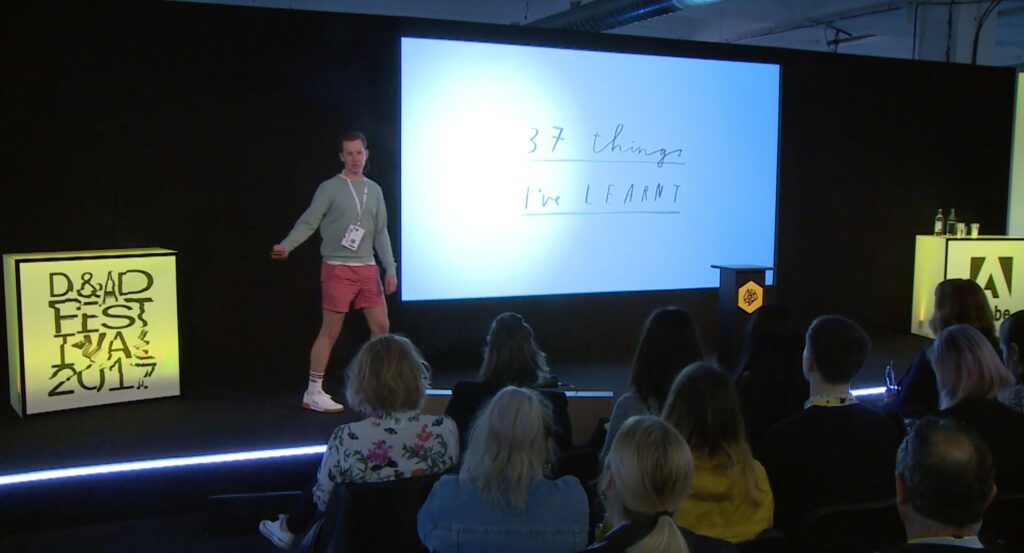 Photograph of man presenting on stage