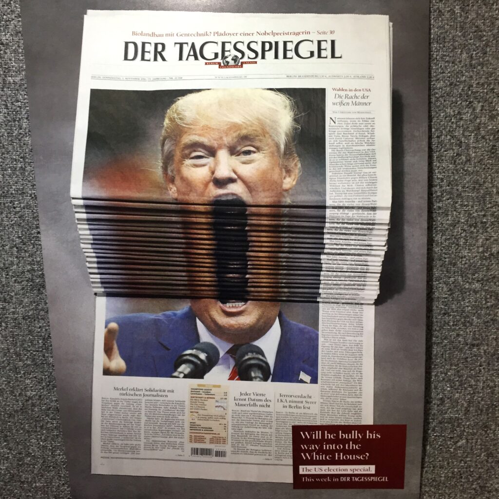 Photograph of stack of newspaper front covers