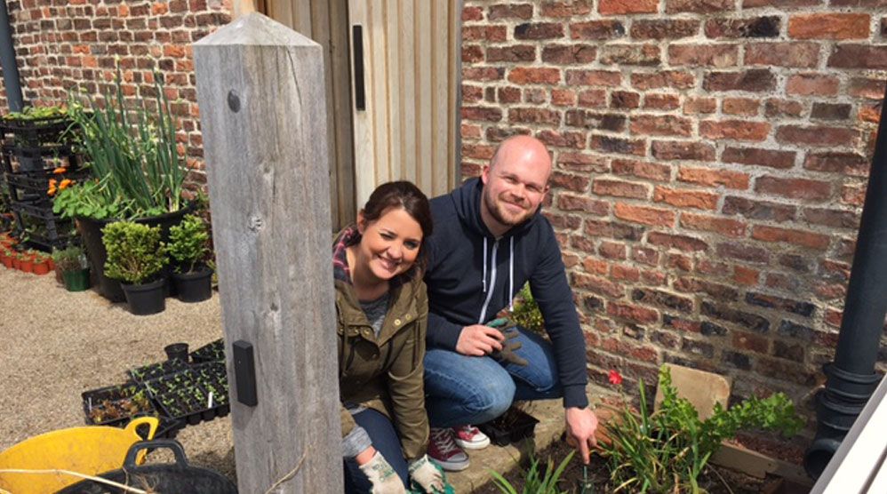 Photo of Craig and Bex gardening