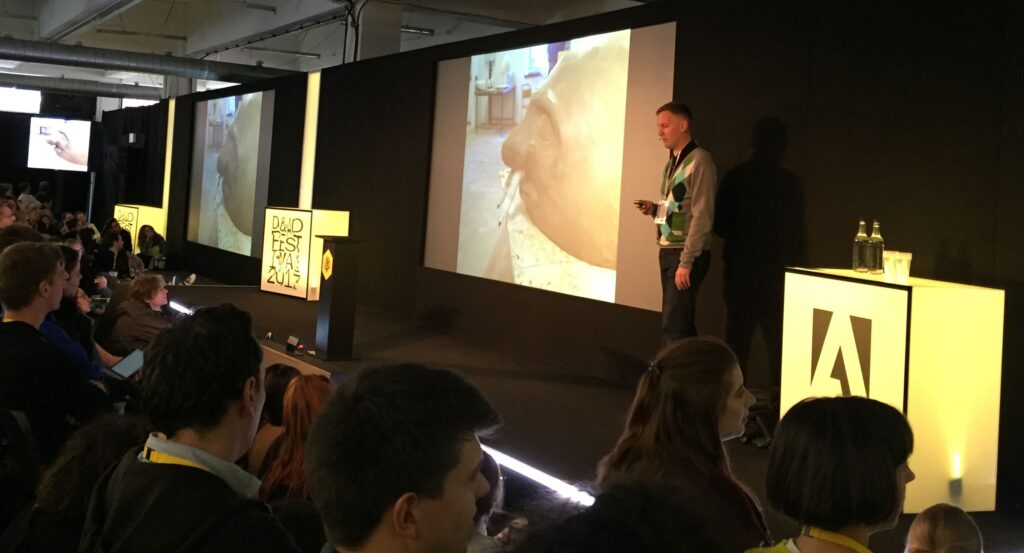 Photo of man presenting on stage