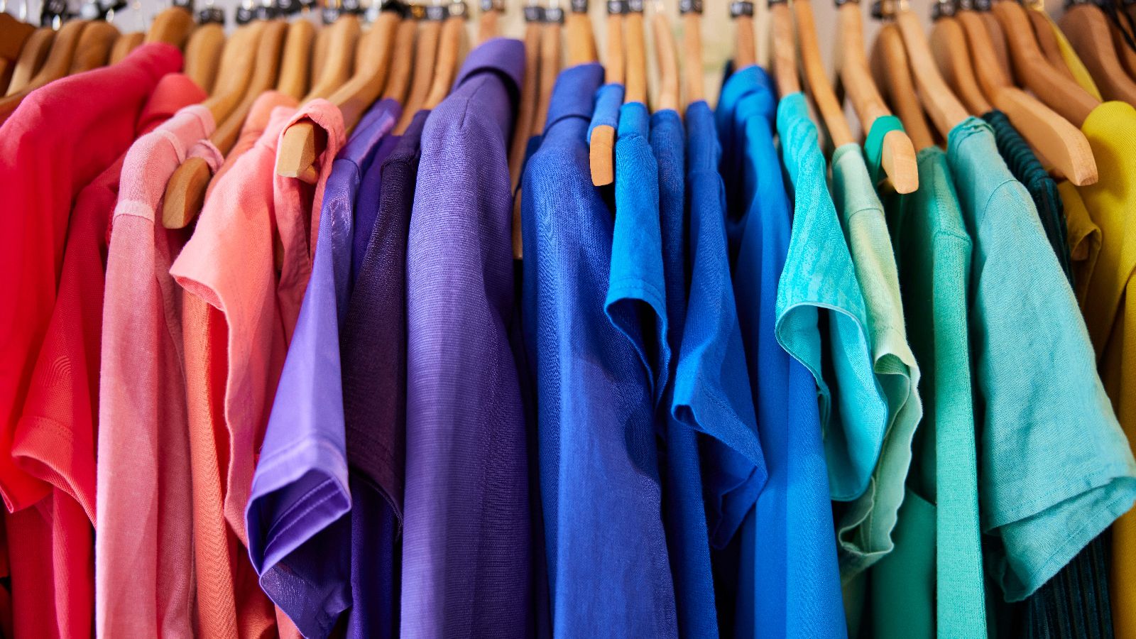 A set of t-shirts on hangers.