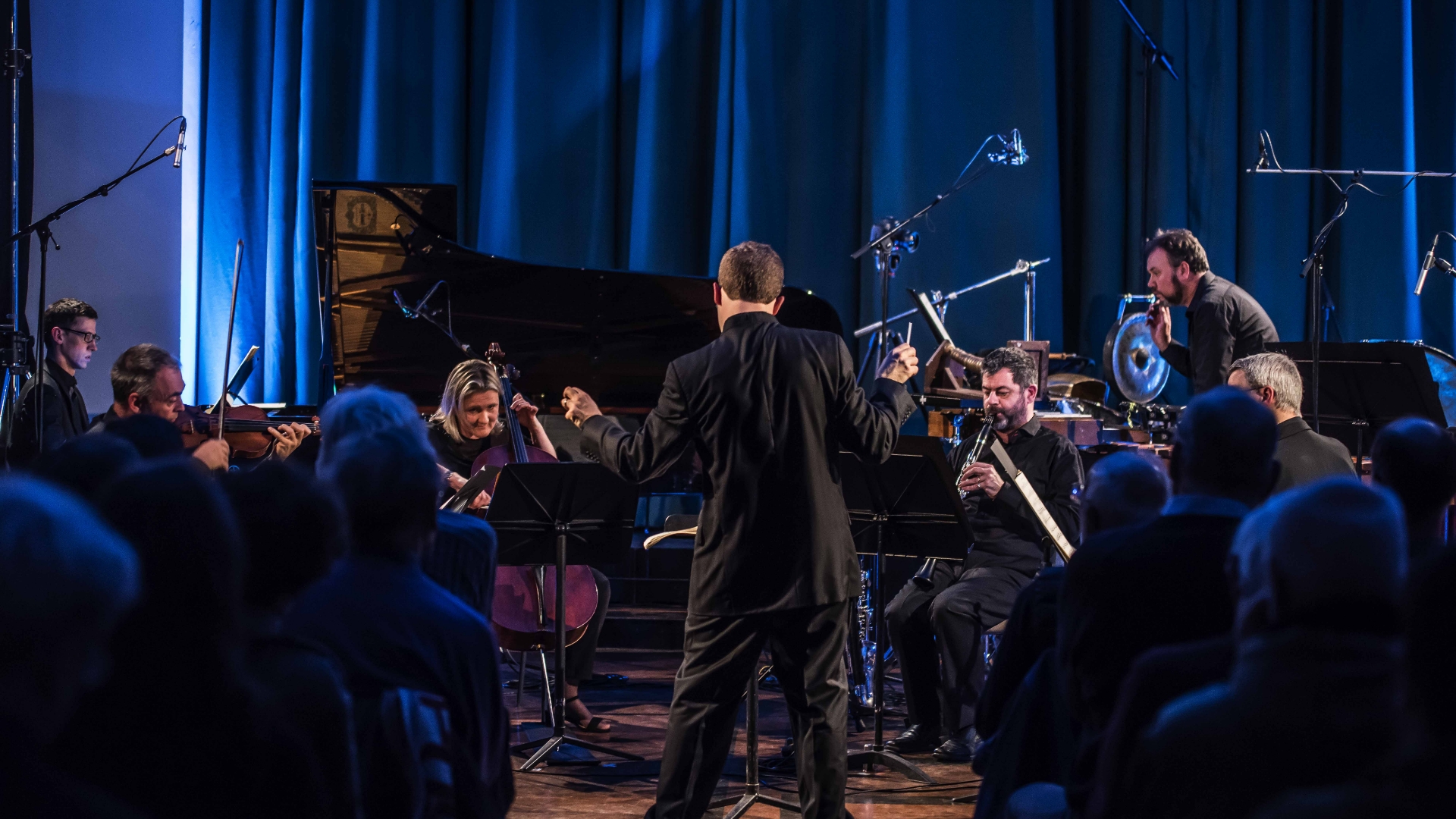 The ensemble performing in front of an audience.