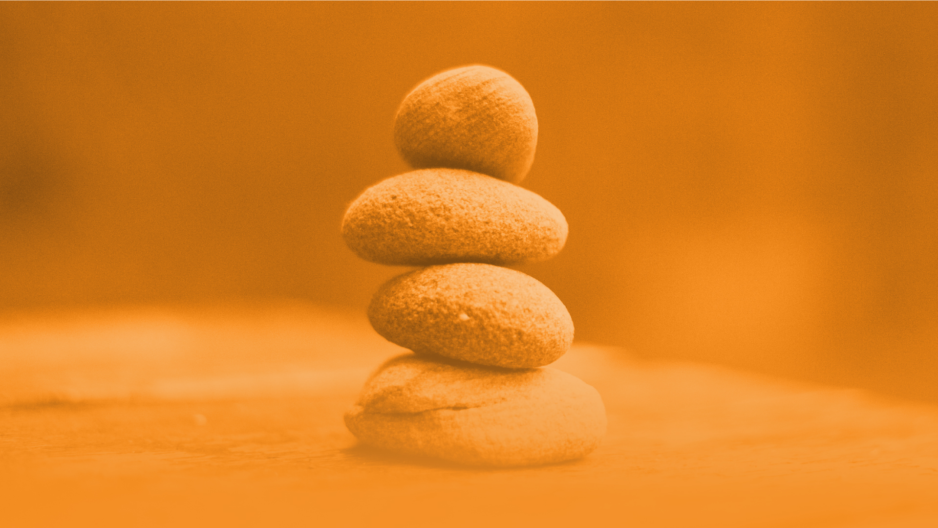 Abstract orange image of 4 stones stacked.